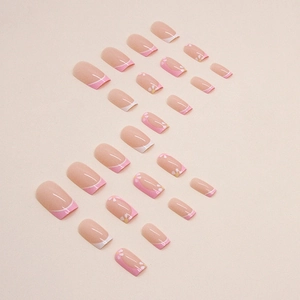 Pink French almond press-on nails featuring white floral patterns and glossy finish