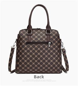 Back view of brown monogram tote bag with leather handles and silver zipper pocket
