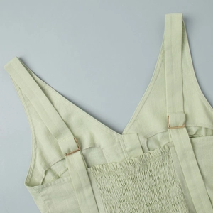 Detail of light green cotton vest featuring smocking elastic back and adjustable straps
