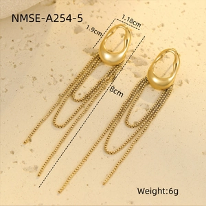 Detailed close-up of gold geometric fringe earrings featuring sleek box chain tassels