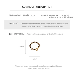 Macro detail of vintage tiger eye and pearl bracelet with specific length measurements