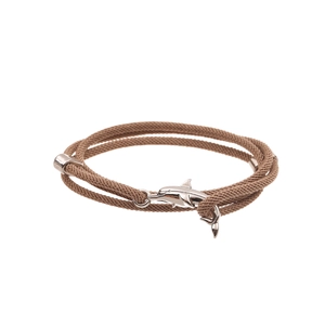 Detail of brown braided cord bracelet with polished silver dolphin pendant closure