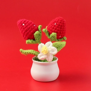 Handmade crocheted strawberry potted plant ornament with red berries in white ceramic pot