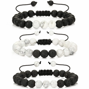 Detail of natural stone bead bracelets with lava rock and turquoise on braided cords