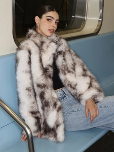 Close-up of plush faux fur coat texture with high collar and natural animal fur patterns