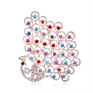 Close-up of rose gold peacock brooch with vibrant multicolored rhinestones and crystals