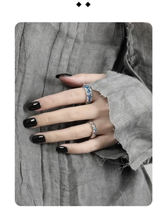 Detailed view of silver s925 rings with blue enamel and gemstones on model hand