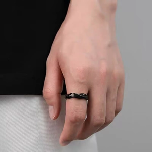 Close-up of black Mobius titanium steel ring worn on index finger for a minimalist look