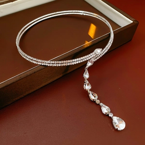 Macro shot of silver double-layered necklace with sparkling teardrop zircon pendants
