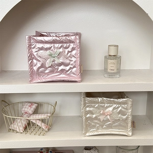 Close-up of quilted bow storage bag with heart pattern and delicate lace trim detail