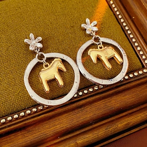 Golden horse pendant earrings with silver flower studs and hollow textured round hoops