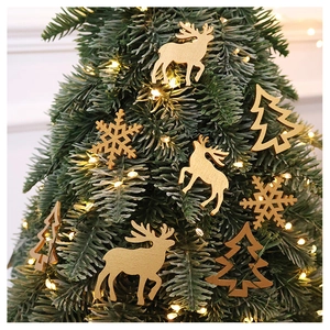 Wooden Christmas ornaments with reindeer and snowflakes among green pine and warm lights
