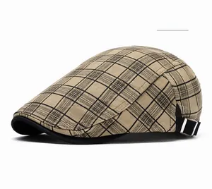 Detail of khaki plaid cotton newsboy hat featuring an adjustable metal side buckle