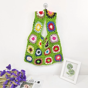 Detail of multi-colored granny square hand-crocheted tote bag with intricate floral patterns