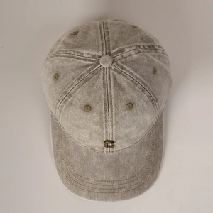 Detail view of khaki washed cotton baseball cap with retro metal buckle and ventilation holes