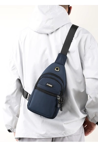 Deep blue water-resistant Oxford cloth chest bag worn by a model in an outdoor setting