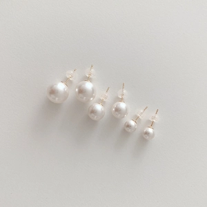Three pairs of white pearl earrings in various sizes with secure silicone backings