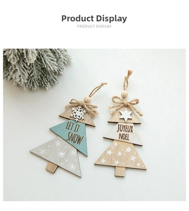 Macro detail of wooden Christmas tree ornaments with Let It Snow and Joyeux Noel text