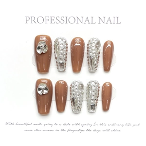 Detail of 10pcs handmade caramel and silver press-on nails with heart rhinestones