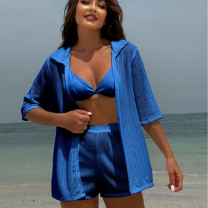 Three-piece cobalt blue pleated beach set with bikini top, shorts and matching cover-up shirt