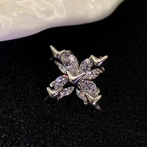 Macro shot of silver zircon cross ear cuff featuring sparkling marquise cut stones