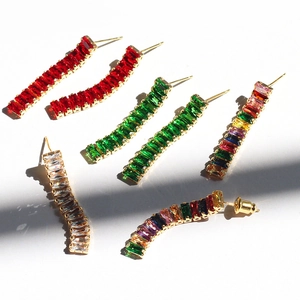 Detailed shot of long curved drop earrings with colorful zircon stones in four color styles