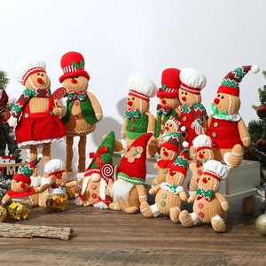 Christmas Gingerbread Gnomes set with red and green hats and glowing lights on wood stand