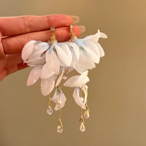 Detailed view of elegant light blue fabric flower dangling earrings with pearls and crystals