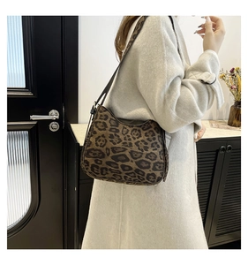 Leopard print hobo bag worn by a model in a stylish beige coat for a casual autumn look