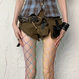 Close-up of rainbow gradient fishnet tights with rhinestone details and high elasticity