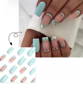 Detail of French press-on nails in light blue and pink with glitters and rhinestones