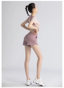 Women's pink short sleeve top with knotted hem and purple high-waisted shorts set