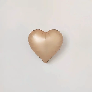 Detail of heart-shaped champagne gold foil balloon for wedding party decoration