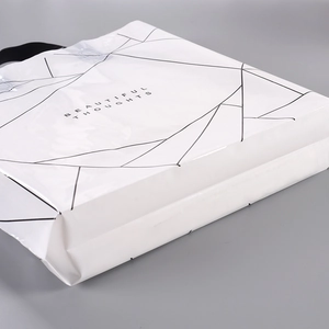 White PE plastic shopping bag with black geometric lines and handle for boutique clothing
