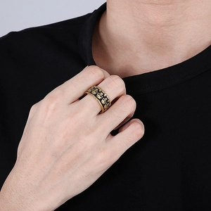 Macro shot of gold vintage skull ring with black relief crown on wide band