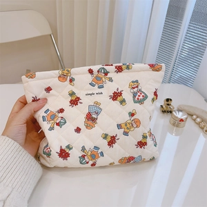 Close-up of quilted cotton makeup bag featuring vintage floral prints and zip closure