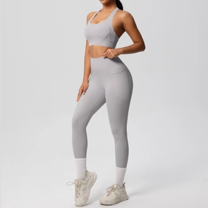 Detail view of high-waisted yoga leggings with side pockets and sports bra set in grey