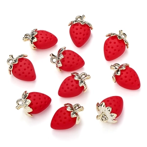 Detailed view of ten red strawberry charms with golden metal leaves for DIY jewelry making