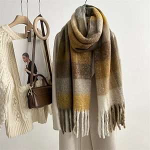 Detailed view of mohair plaid scarf with tassels, styled in a warm autumn fashion set