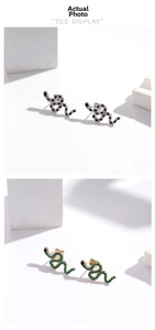 Detailed view of snake-shaped earrings in silver and gold finishes with zircon stones