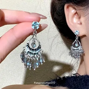 Elegant silver tassel earrings with light blue zircons and crystals in waterdrop design