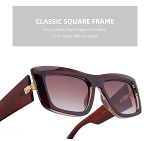 Detail of classic square cat-eye sunglasses with amber frame and brown gradient lenses