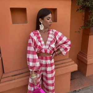Pink and white checkered two-piece set with V-neck crop top and high-waist pants
