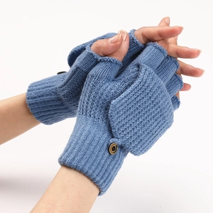 Close-up of blue knitted fingerless flip gloves with button detail and striped texture