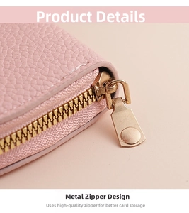 Detail of pink lychee grain leather wallet featuring premium light gold metal zipper