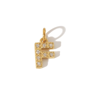 Close-up of a gold-plated letter F pendant with pavé-set cubic zirconia stones