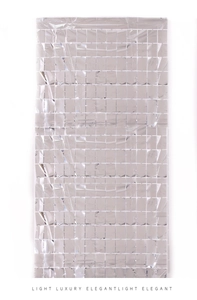 Close-up of silver square foil fringe curtain with metallic reflective grid for parties