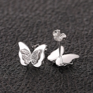 3D butterfly stud earrings with silver hollow design and white enamel layering for women