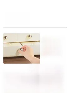 Detail of cosmetic storage box featuring golden round handles and 360-degree rotating tray
