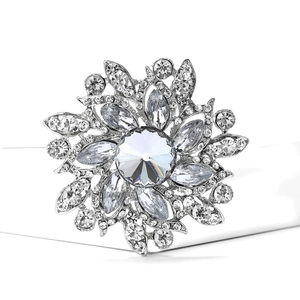 Macro shot of sparkling crystal flower brooch with silver metal floral details